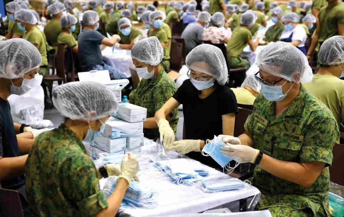 MINDEF and SAF personnel packing masks for distribution to residents islandwide